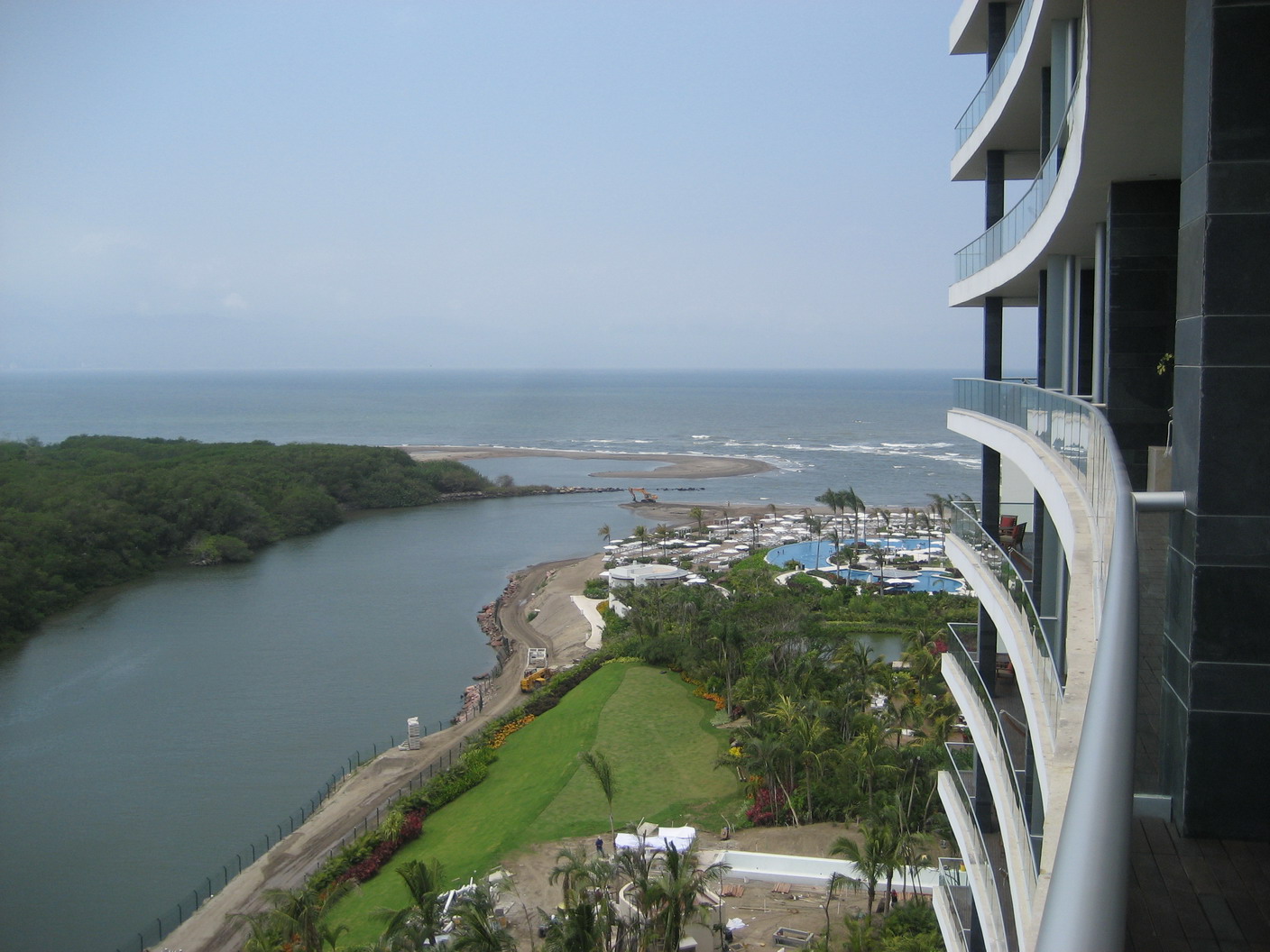 This photo shows a panoramic view of la punta beach.  The Ameca River meets the Bahia de Banderas a la punts (at the tip) de Nuevo Vallarta, where sand and rocks improve the beach in front of the Grand Luxxe Residence Club units.