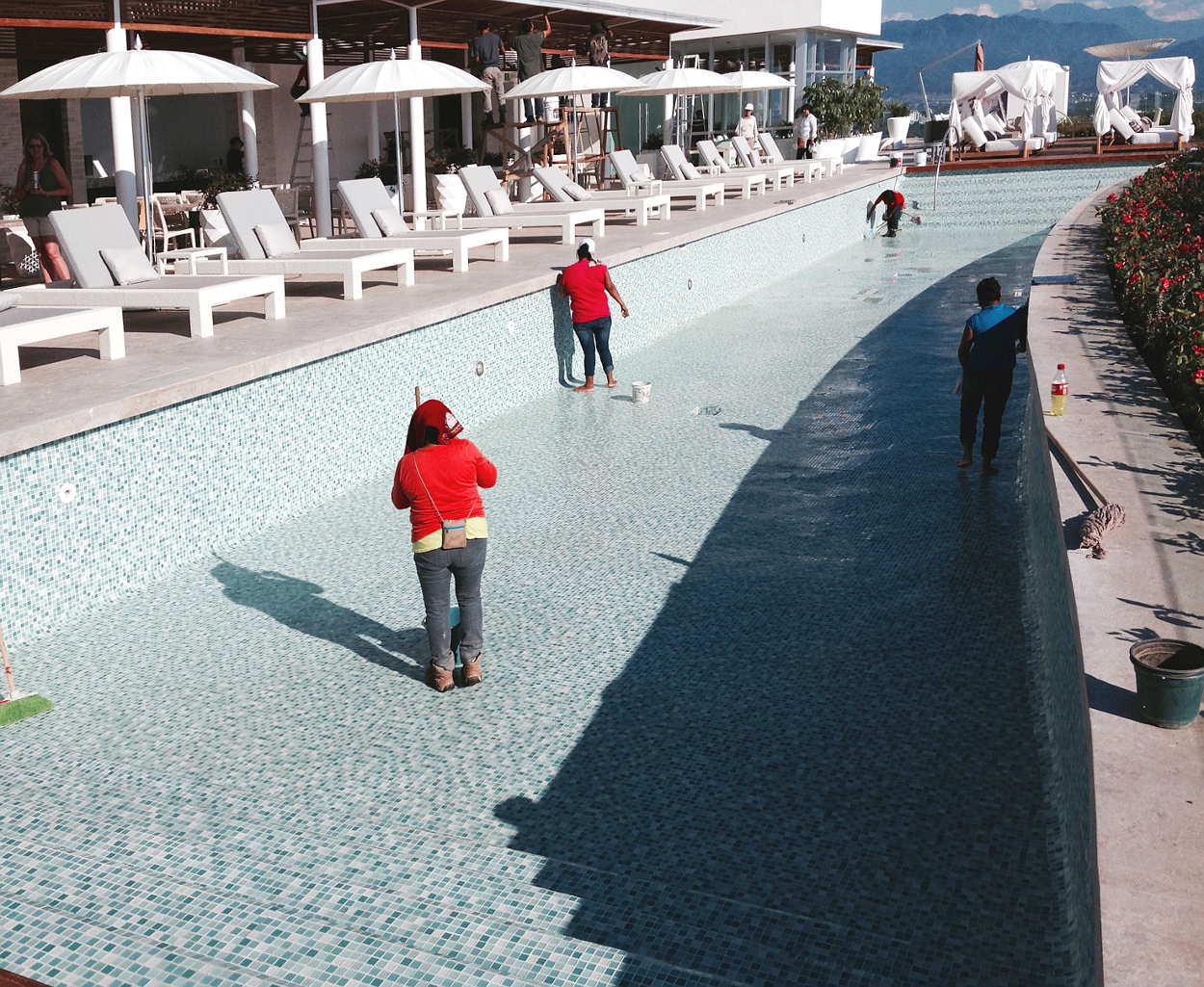 The Rooftop Pool and Restaurant at the Residence Tower have great views.  Here, a crew is cleaning the pool in preparation for the opening.  May occur any time.