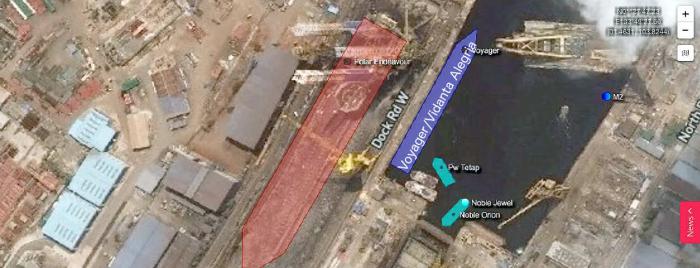 Vidanta Alegria is moored along side what appears to be a dry dock at a Singapore shipyard.