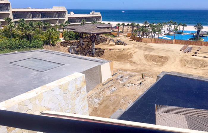 This view shows the construction from behind the fence that separates the pool area from the construction.  BTW, does it look as though there are Luxxe sized units under construction in the area behind and above the construction, or is just us?